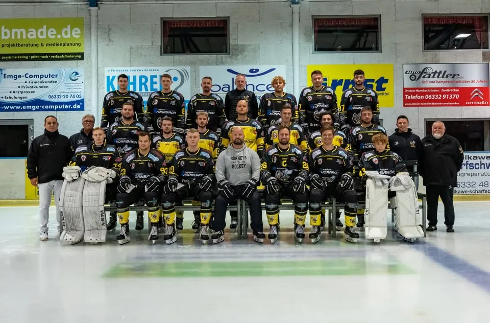 Mannschaftsfoto des EHC Zweibrücken Hornets e.V. auf dem Eis, aufgestellt in Trikots vor der Bande